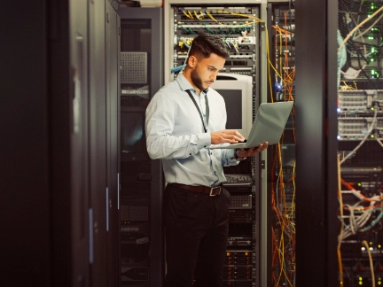 Young male worker in computer room