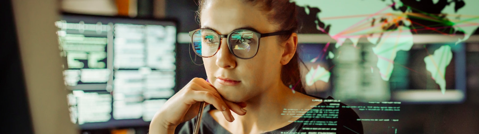 Young female IT worker looking at screen