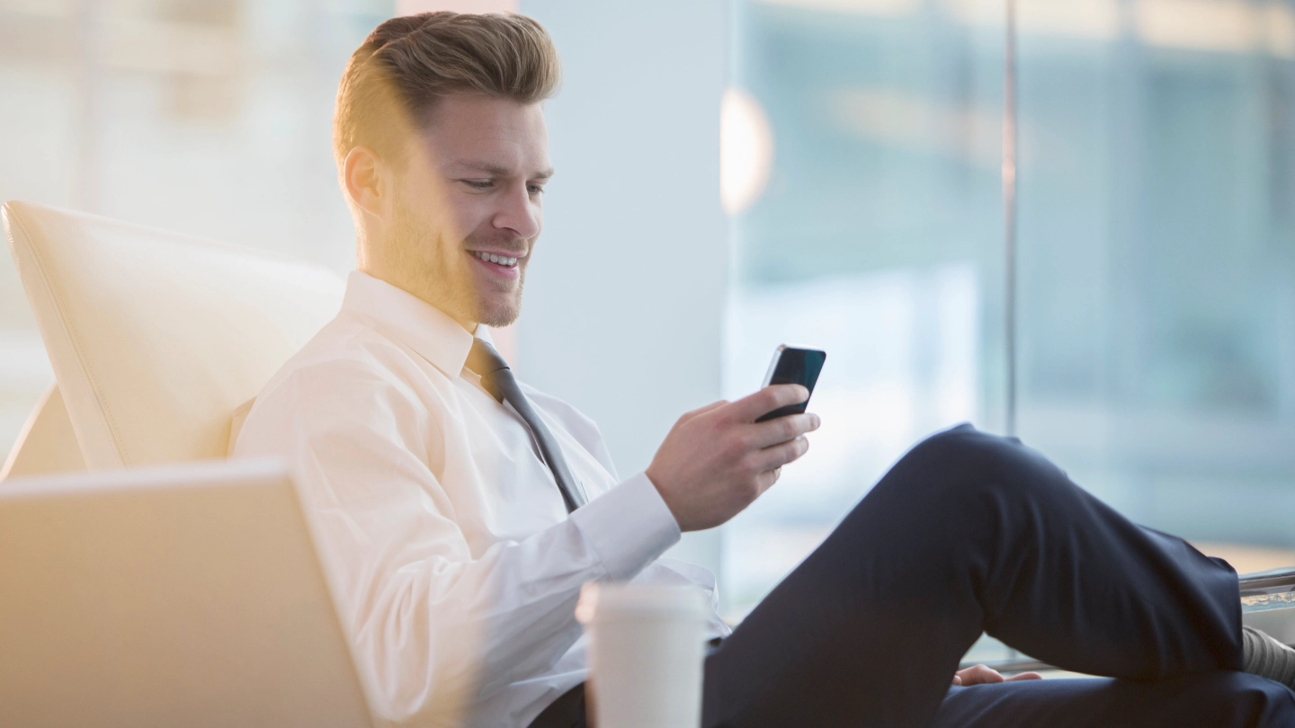 man_relaxed_with_smartphone_fullcolor_3c_hr image