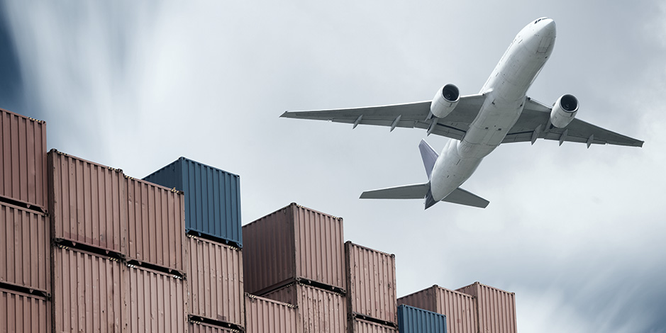Airplane flying over containers